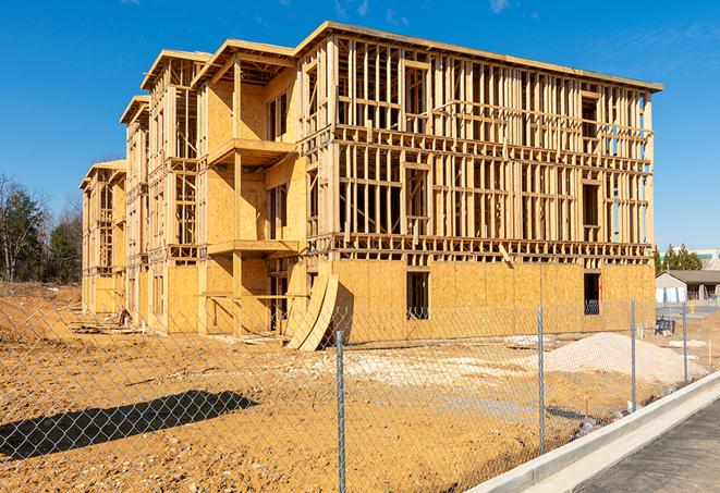 a close-up of temporary chain link fences enclosing a job site, signaling progress in the project's development in Lancaster